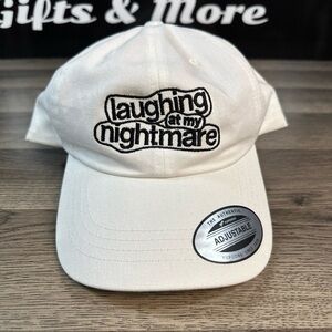 The White Adjustable Hat laughing at my nightmare.